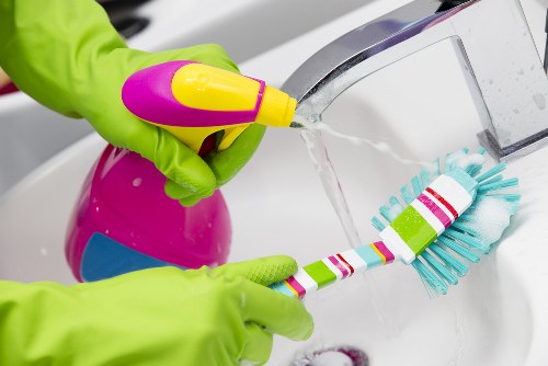 Cleaner wearing protective gear during carpet cleaning task